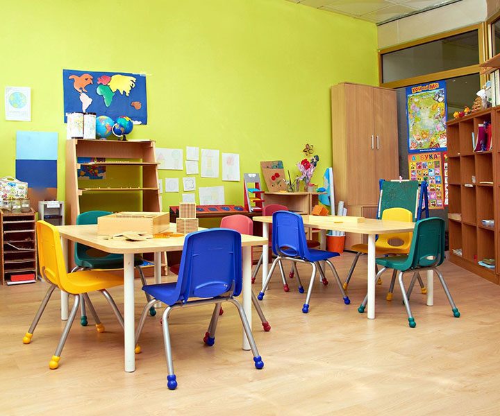 A classroom with tables and chairs in it